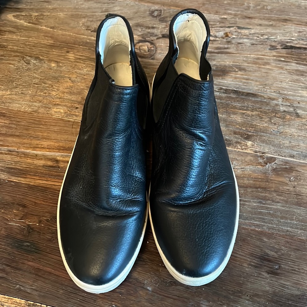 Fly London black leather sneaker with gold fly on back